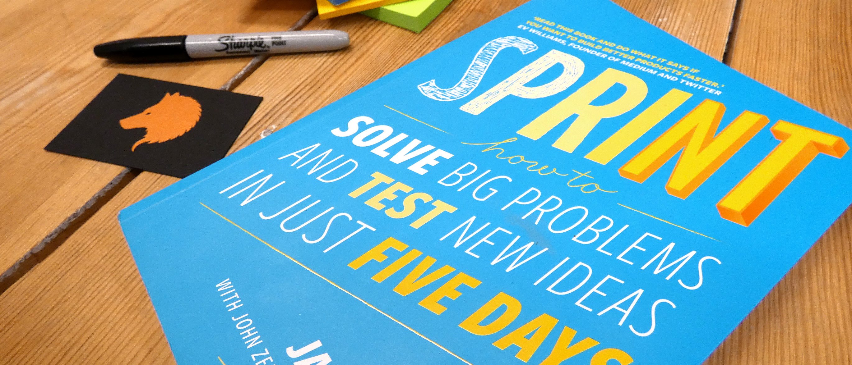 Design Sprint book on wooden table